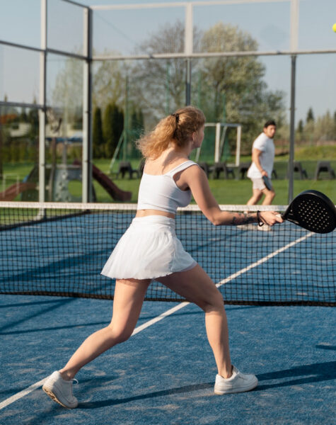full-shot-friends-playing-paddle-tennis-outdoors